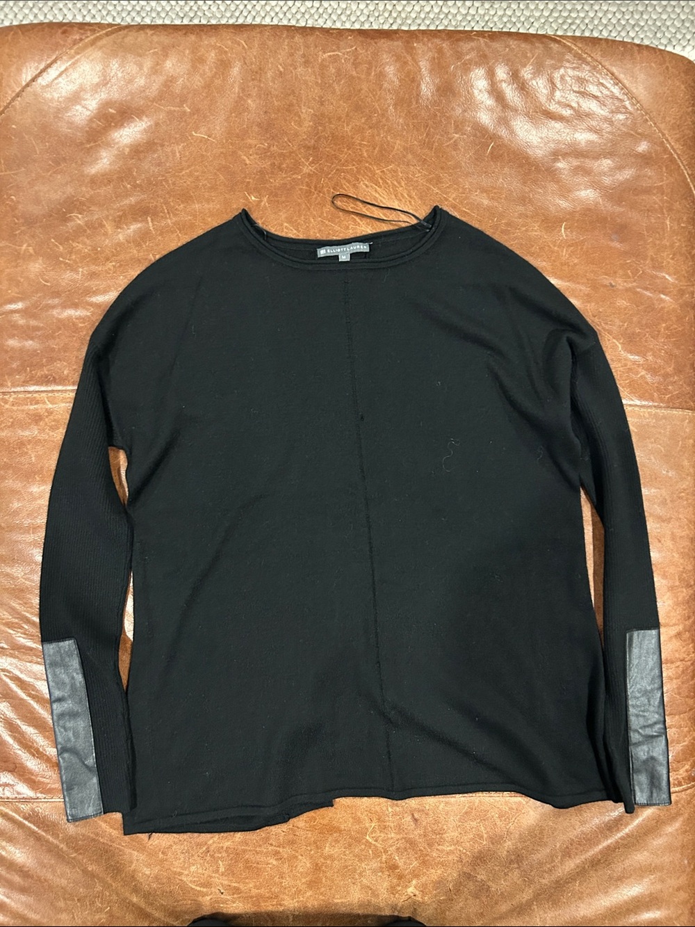 women's black knit tunic top with distinctive faux-leather sleeve paneling